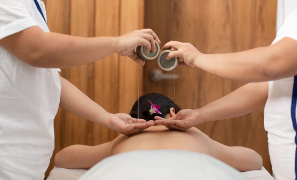 Relaxing massage session at Makkha Spa in Chiangmai with a scenic view through large windows.
