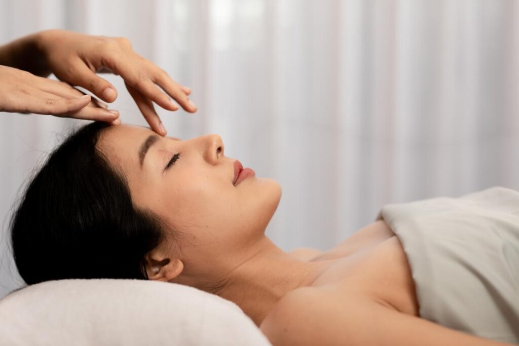 A woman receiving an Indian head massage