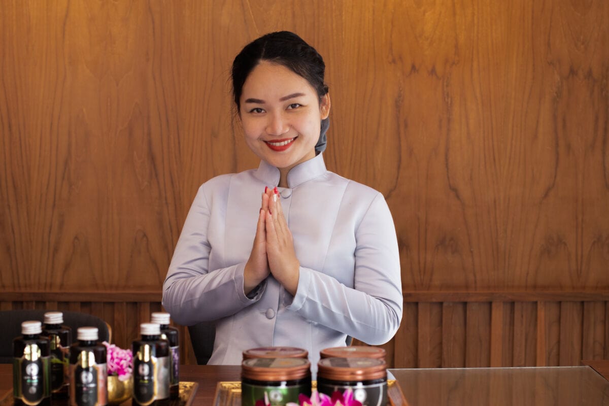 A Makkha Health & Spa therapist greeting with traditional gesture