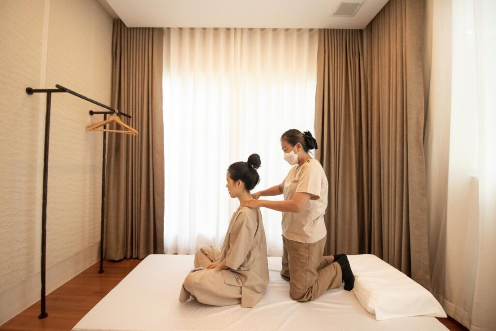 A woman receiving a back, neck and shoulder massage service