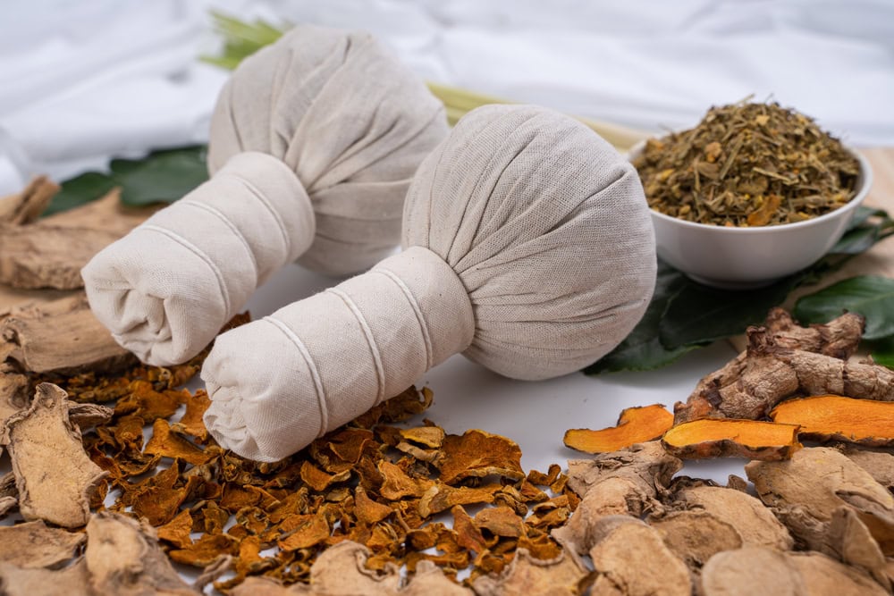 Soothing herbal compress balls with dried herbs and roots for traditional Thai massage at Makkha Spa in Chiang Mai.