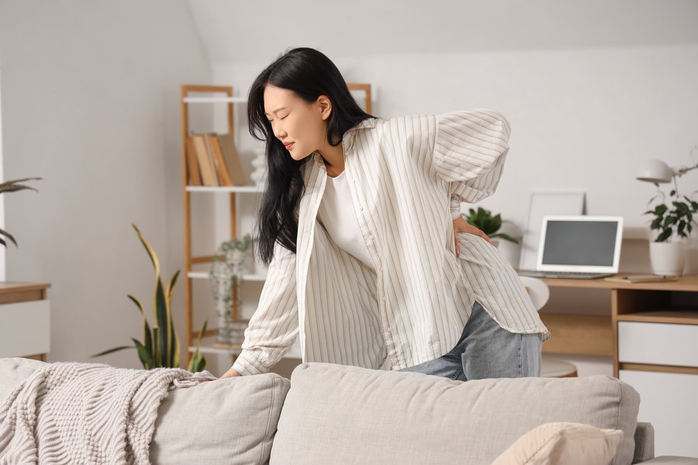 A woman suffering from lower back pain